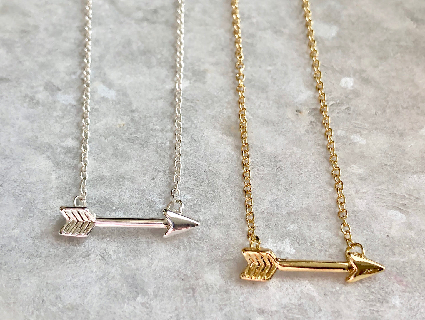 Arrow Pendant Necklace in silver, gold, and rose gold.